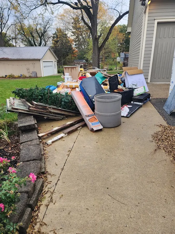 Dumpster being loaded with debris for Estate Cleanout Dumpster Rental in Santa Rita Ranch